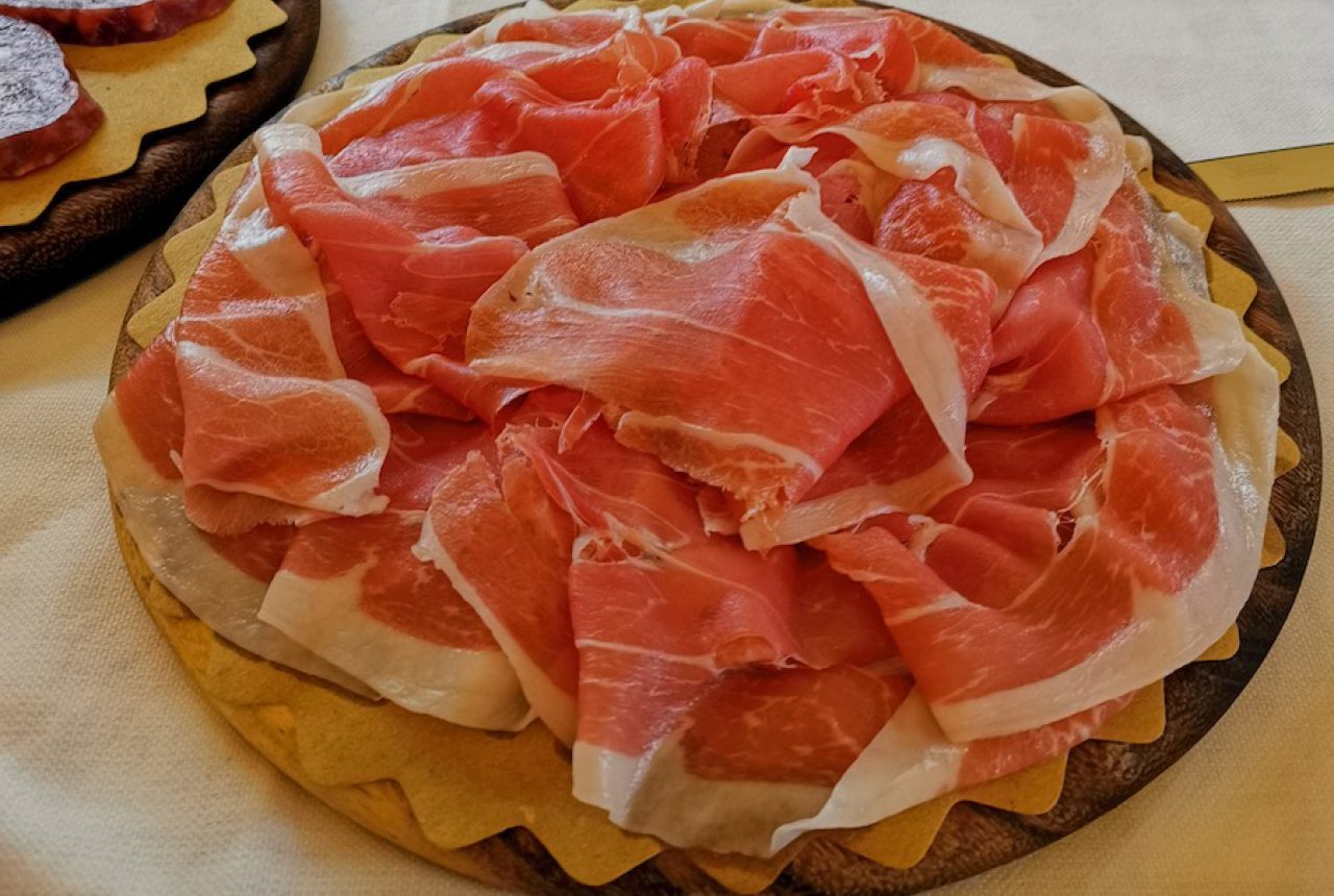 Prosciutto di Parma affettato su tagliere